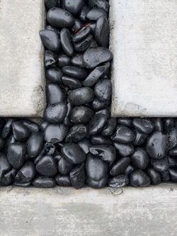 Polished black pebble rocks