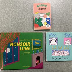 Children's board books, one in English and two in French. 