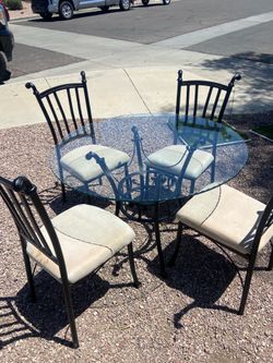 Dinning glass table w four metal chairs  100