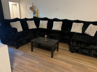 Black Sectional Sofa with Grey Throw Pillows