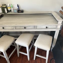 light grey desk/work table/bar with 3 stools