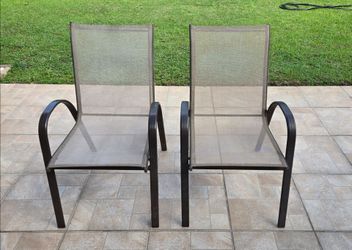 2 sling back stackable patio chairs used brown some rust see pictures