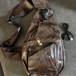 New.  Shoulder bag with charging pouch and cord.