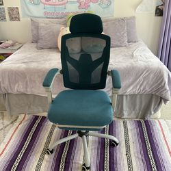 dark blue rolling chair with foot rest