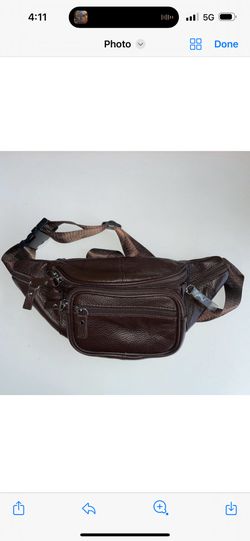 This versatile brown leather waist bag is designed for functionality and style. Made with high-quality leather, it features multiple zippered compartm