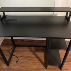 Black desk with built in outlet