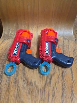 Two toy X-Shot pistols