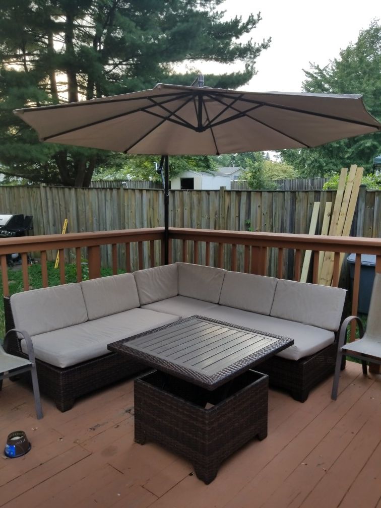 Ashley's Furniture sectional outdoor sofa with retracting umbrella