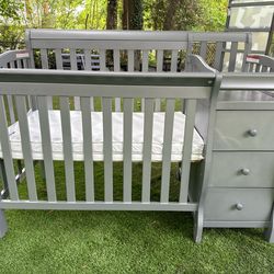 Gray baby crib with with mattress and changing table