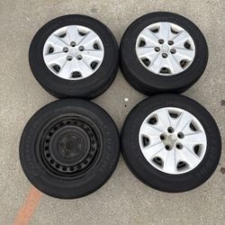 4 Rims And Tires One Missing Hub Cap  