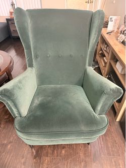 Green velvet upholstered arm chair