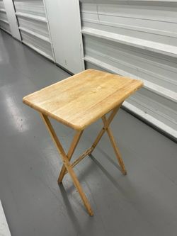 Wooden folding portable table made of natural wood