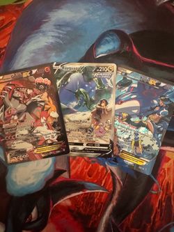 Team Magma’s Groudon, Team Aqua’s Kyogre, and Zinnia’s Rayquaza binder