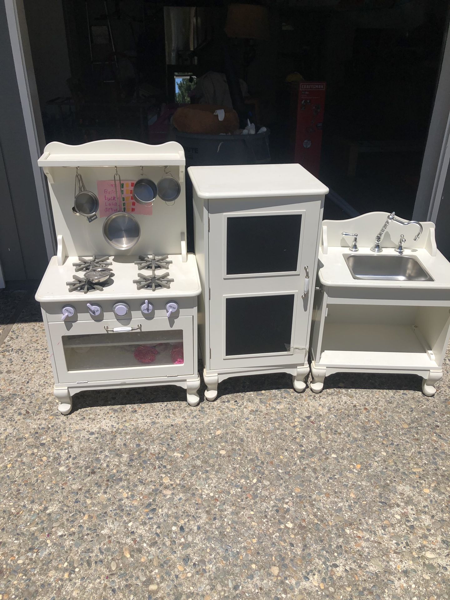 Pottery barn wooden kitchen set comes with pots pans a fridge full of food.