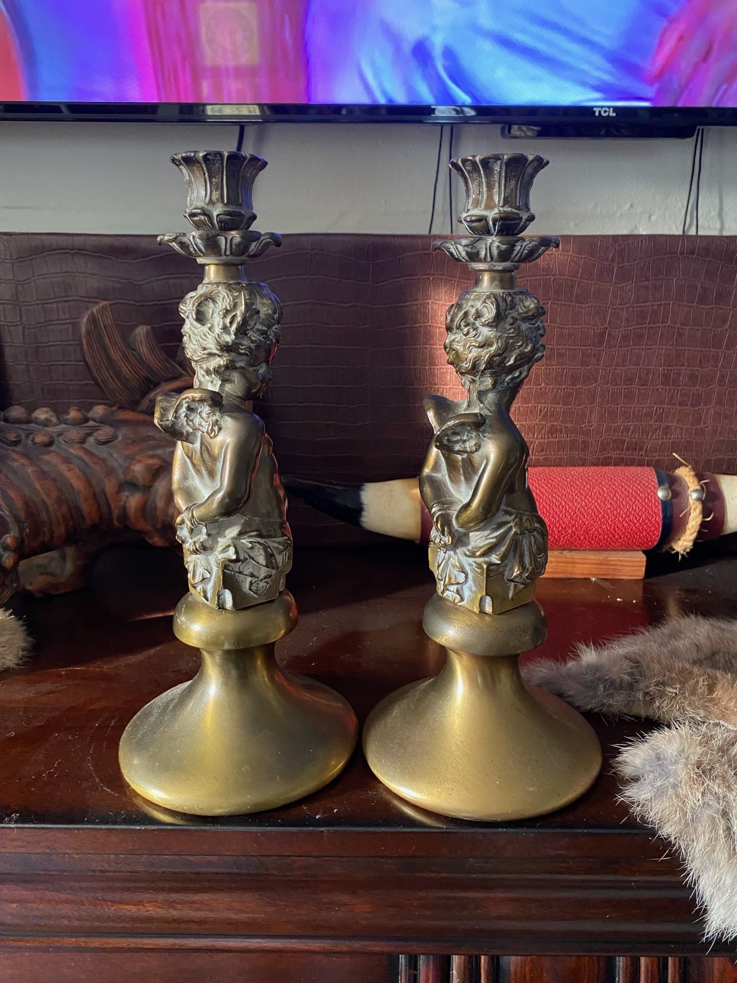 bronze cherub candlestick holder, possibly antique, reflecting a neo-classical design