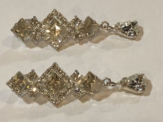 Two bright shiny sparkly pins brooches