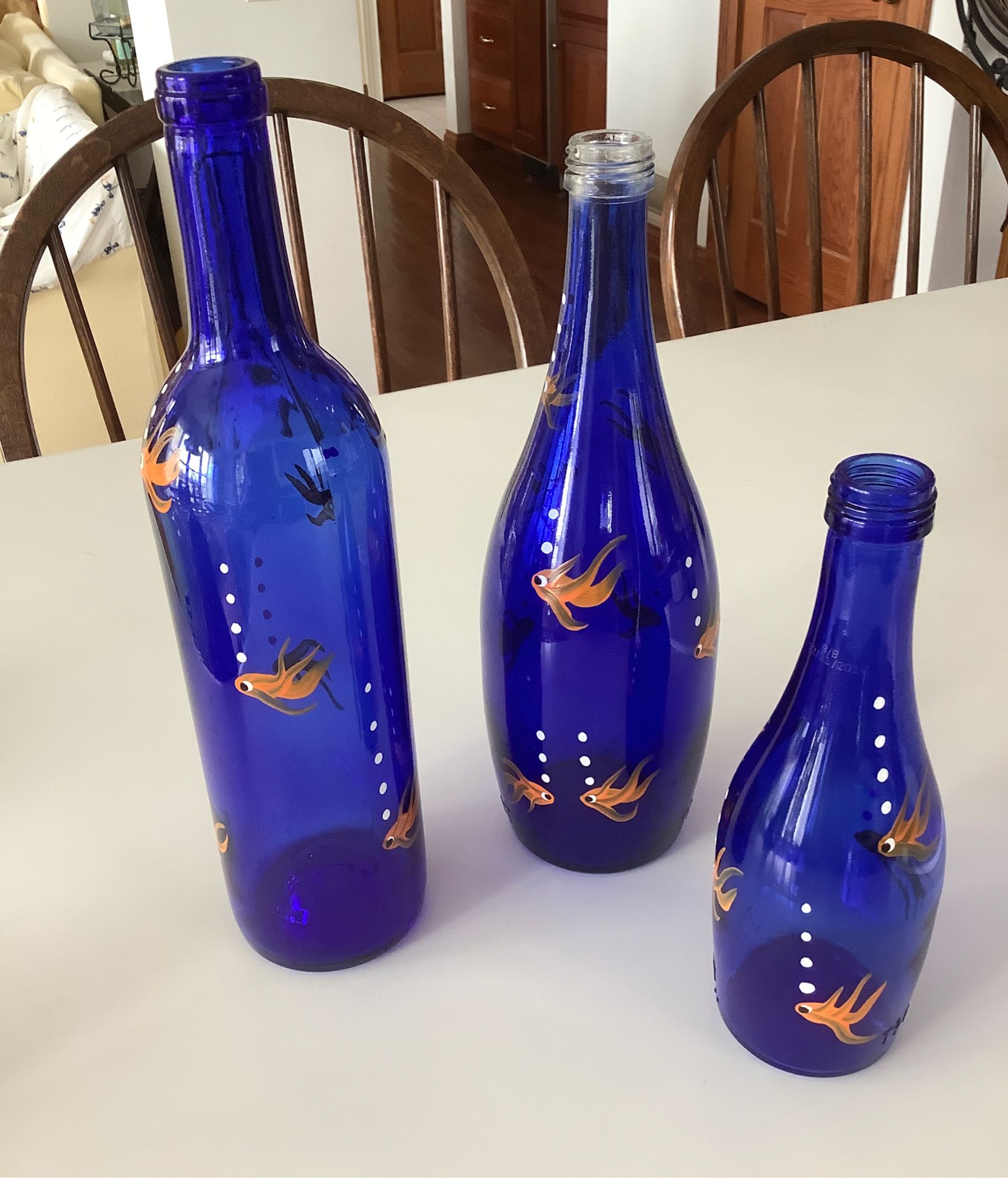 Blue glass bottles with hand painted fish