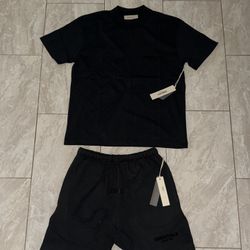 black T-shirt and shorts set from the brand Fear of God Essentials