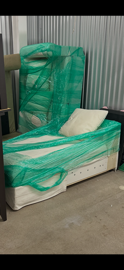 2 white sofas - one sofa is a couch, second sofa is a sleeper sofa with storage room underneath
