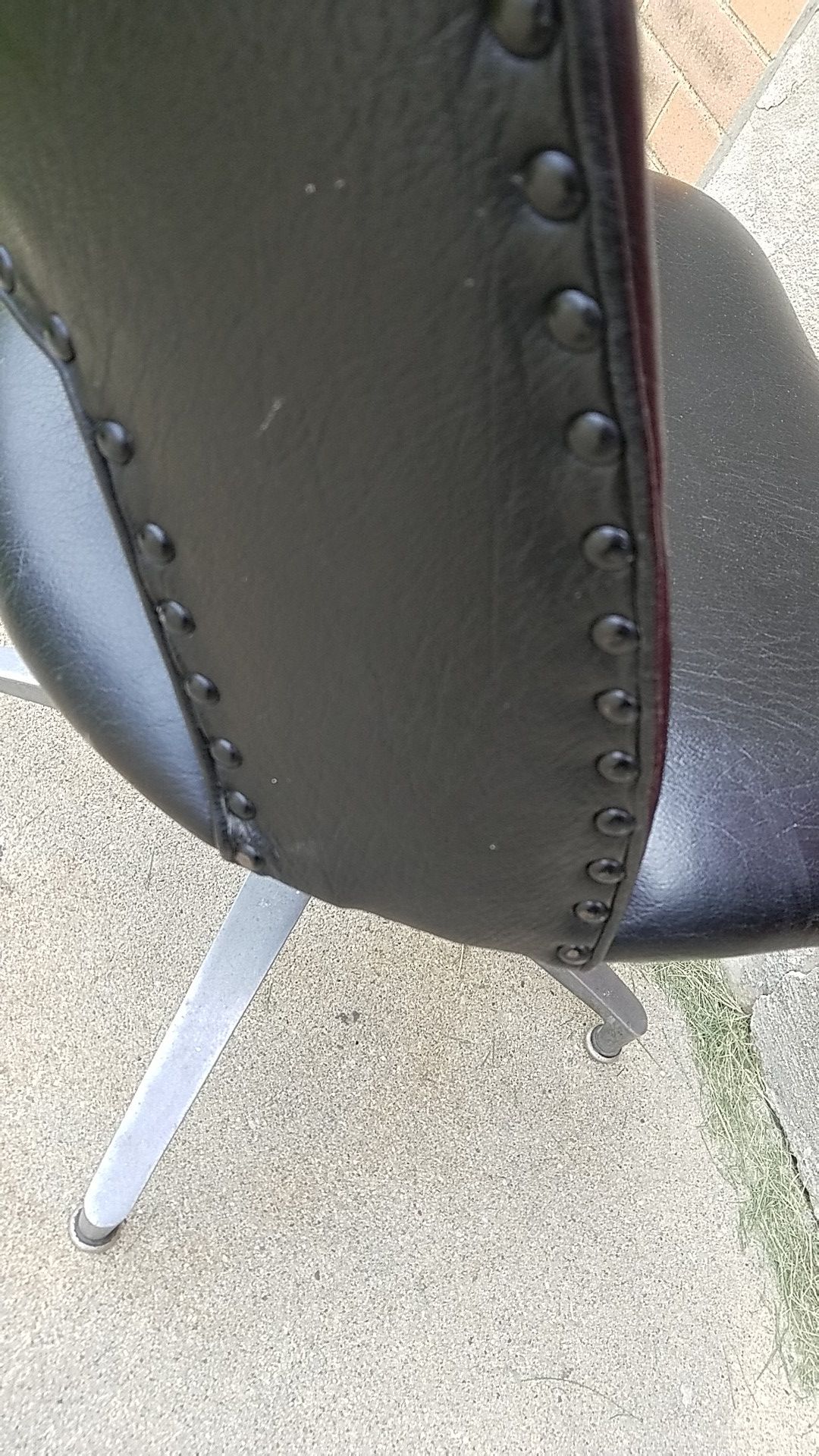 MCM black studded vinyl swivel chair