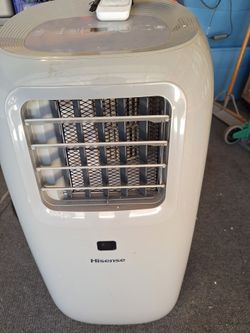 PORTABLE AIR CONDITIONER WITH HOOKUP. HISENSE BRAND 6,500 BTU ON ROLLERS.