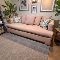 Vintage Pink Couch With Floral Pillows 