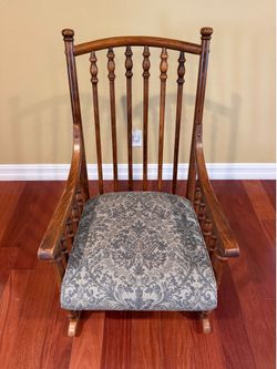 Vintage wooden rocking chair with cushions