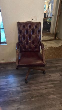 traditional-style burgundy leather tufted executive office swivel chair with nailhead trim.