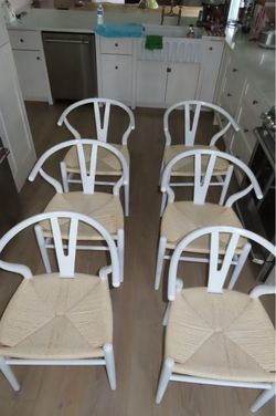 Set of 6 Poly & Bark wishbone dining chairs with white frames and natural woven seats.