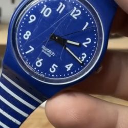 Swatch Gent watch in the "Up-Wind" model (GN230) featuring a navy blue dial with white striped 