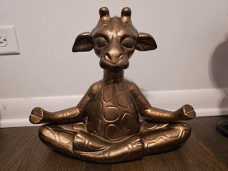 Meditating giraffe sculpture