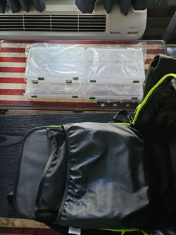 Brand new fishing backpack with plastic storage containers.