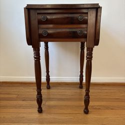 Antique mahogany drop-leaf side table with two drawers and turned legs