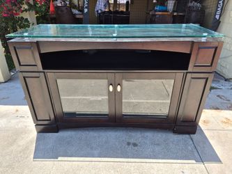 Dark wood and thick glass top entertainment center