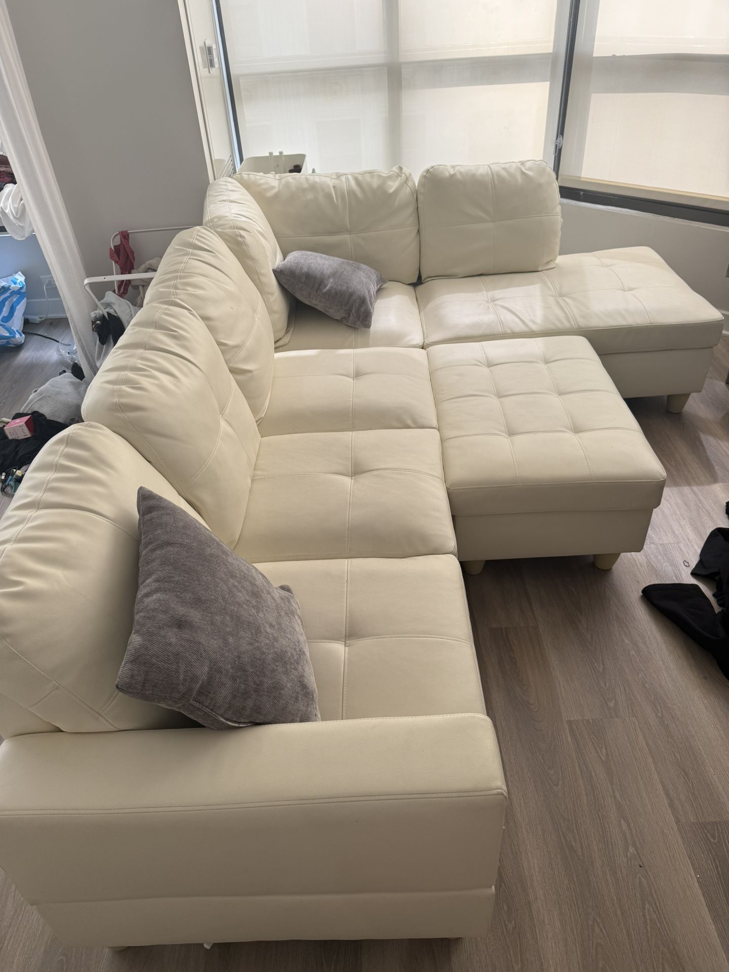 white L shape couch with ottoman