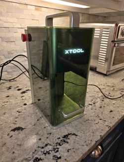 XTool F1 dual laser engraver with RA2 rotary attachment.