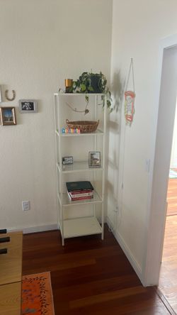 Painted white metal ikea bookshelf with glass shelves