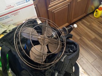 Vintage car defroster fan clamps on the car column