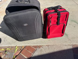 Travel suitcases, one carry-on, red, and one check-in black