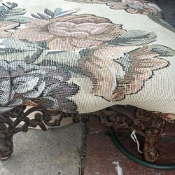 vintage tapestry footstool with a floral design and cast iron legs
