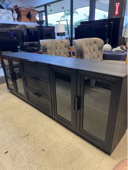 black wood media console is the Crate & Barrel Calypso 90" model, featuring iron hardware and glass door panels - Excellent Condition- Retail: $2600