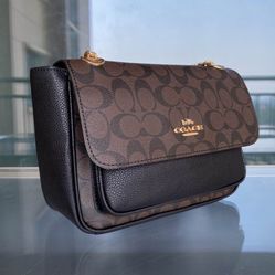 Coach Klare Crossbody 25 in Signature Canvas, featuring a brown monogram design combined with black leather