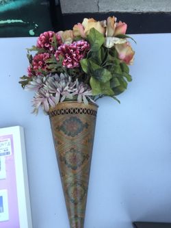 Decorative metal wall vase with artificial flowers