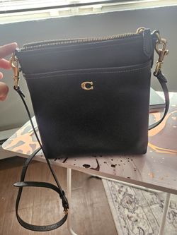 Coach black leather crossover bag with traditional brown labeled lining