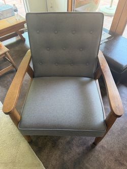 Mid century modern style chair with grey tufted fabric back
