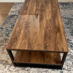 Coffee table brown rustic wood, black metal sides.  23X42 inches 