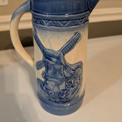 antique Delft style blue and white stoneware pitcher with a Dutch windmill landscape design