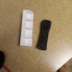 Black Nintendo Wii Renote And White Wii Remote Charger