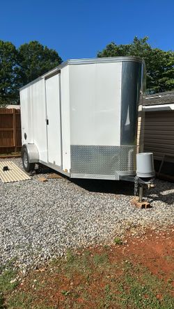 14ft Fold Down Bed In Back And Table In Front. Has Tie Down Points. Checker Flooring. 7000 Obo