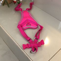 Hot pink nearly new dog harness for a dog leash. In excellent condition. Could also fit around a very fat cat. Size small